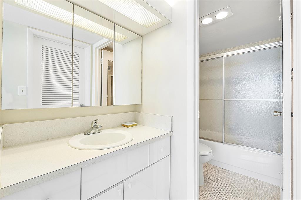1620 South Ocean Boulevard, Unit 15J Lauderdale-by-the-Sea, FL 33062 - Photo 12 of 28 a bathroom with a sink and a mirror