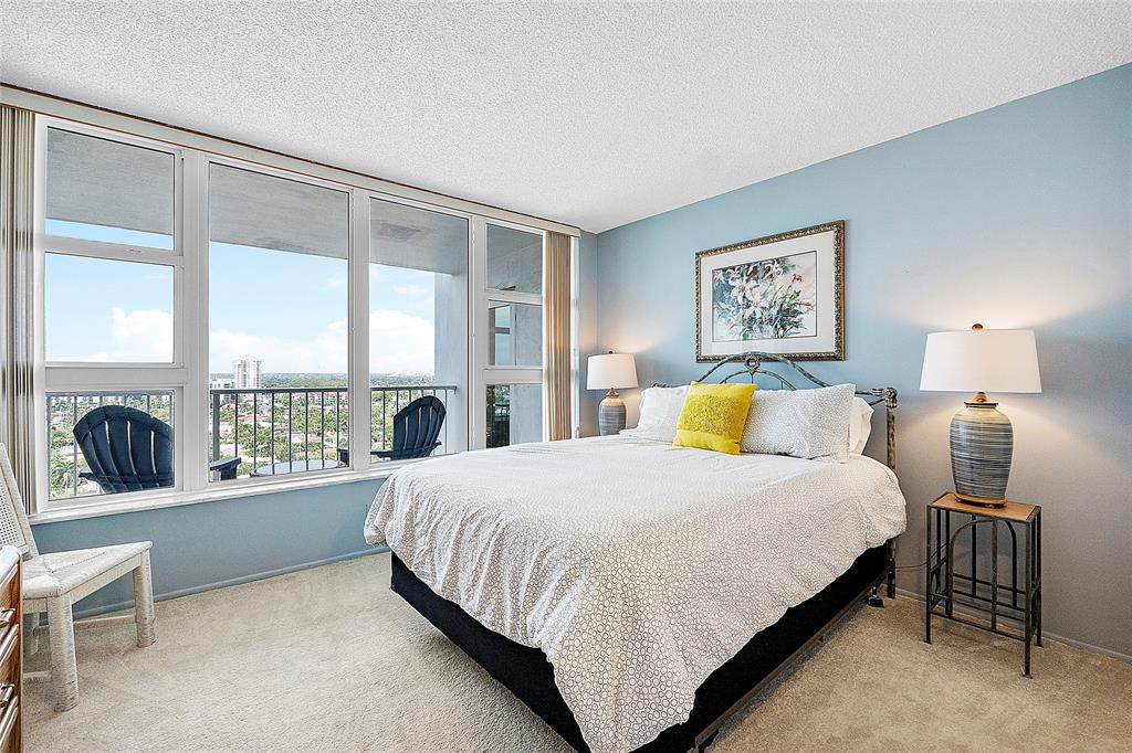 1620 South Ocean Boulevard, Unit 15J Lauderdale-by-the-Sea, FL 33062 - Photo 13 of 28 a bedroom with a large bed and a large window