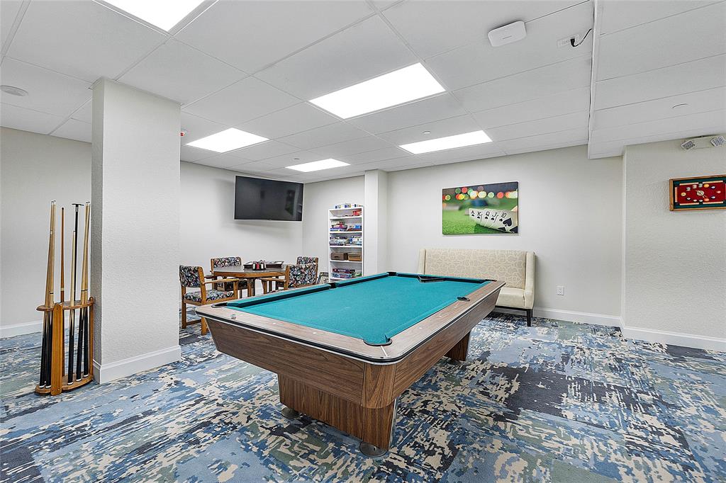 1620 South Ocean Boulevard, Unit 15J Lauderdale-by-the-Sea, FL 33062 - Photo 16 of 28 a room with pool tables and a projector