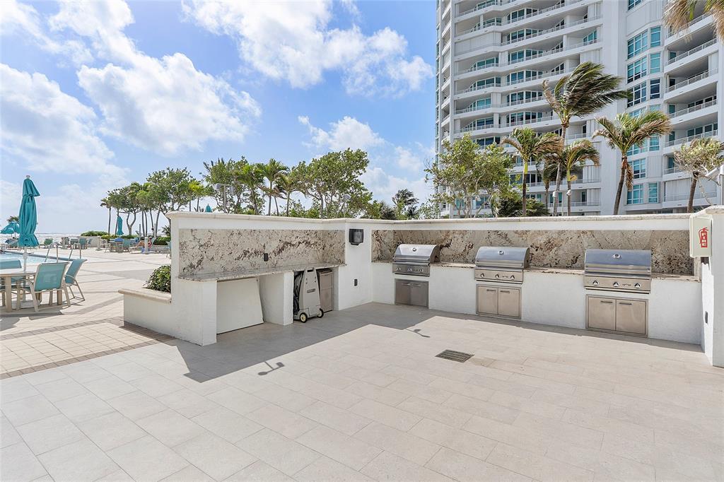 1620 South Ocean Boulevard, Unit 15J Lauderdale-by-the-Sea, FL 33062 - Photo 19 of 28 a view of a white building with outdoor seating and a oven