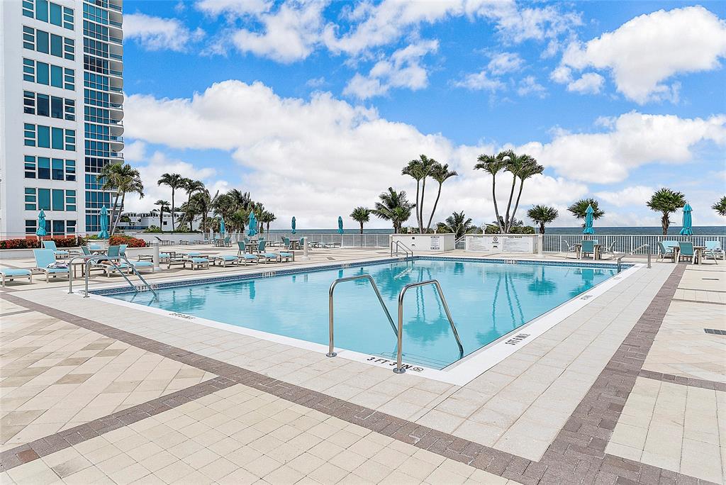 1620 South Ocean Boulevard, Unit 15J Lauderdale-by-the-Sea, FL 33062 - Photo 2 of 28 a view of swimming pool with outdoor seating