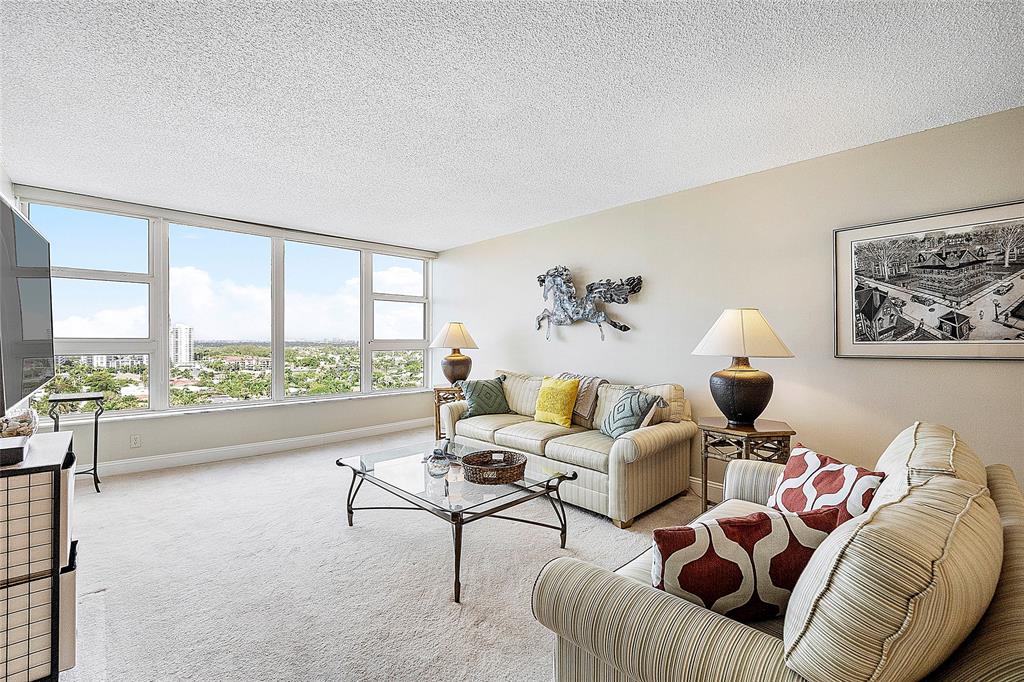 1620 South Ocean Boulevard, Unit 15J Lauderdale-by-the-Sea, FL 33062 - Photo 21 of 28 a living room with furniture and a large window