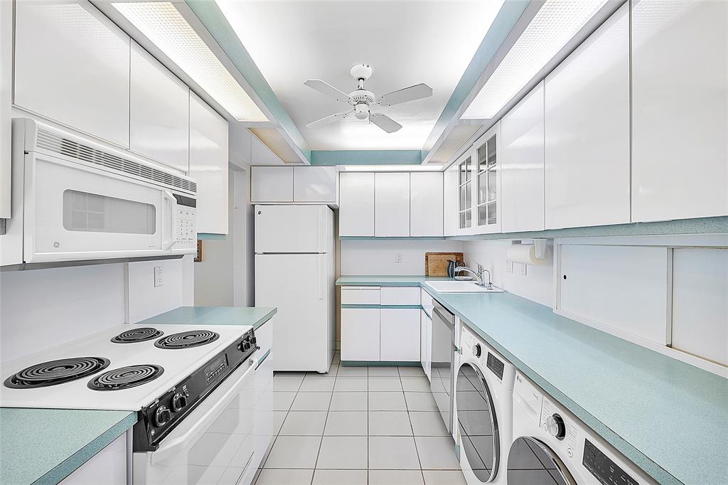 1620 South Ocean Boulevard, Unit 15J Lauderdale-by-the-Sea, FL 33062 - Photo 8 of 28 a kitchen with granite countertop a sink stove and refrigerator