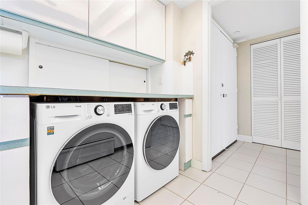 1620 South Ocean Boulevard, Unit 15J Lauderdale-by-the-Sea, FL 33062 - Photo 9 of 28 a view of washer and dryer with kitchen in the background