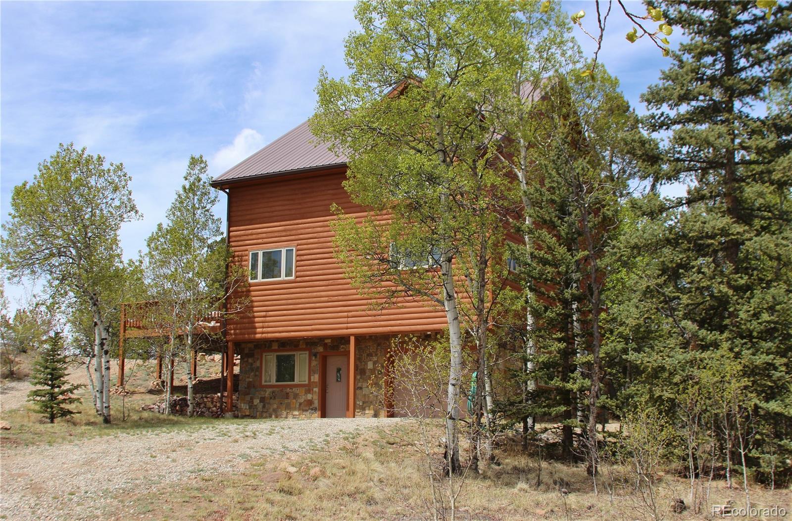 8221 Remington Road Como, CO 80432 - Photo 2 of 49 a house that has a tree in front of the house