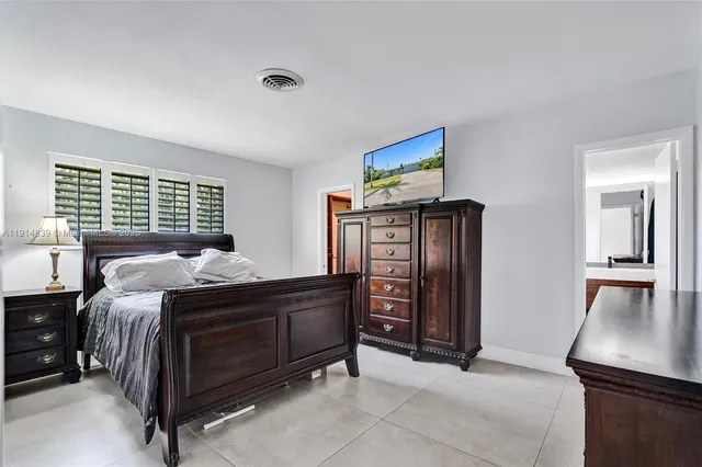 a bed room with a bed and a television