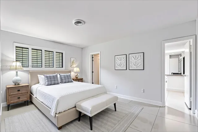 a bedroom with a bed and a night stand