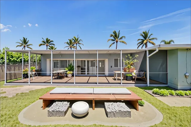 a view of a house with swimming pool and sitting area