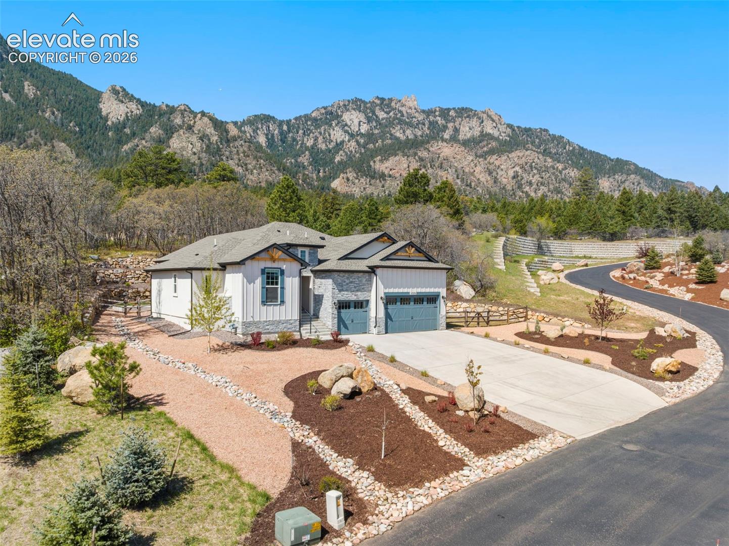 5375 Old Star Ranch View Colorado Springs, CO 80906 - Photo 1 of 47 Contemporary mountain home featuring a stone and siding exterior, a two-car garage, and a concrete driveway