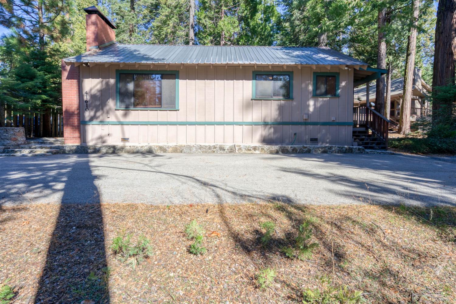 41593 Tollhouse Road Shaver Lake, CA 93664 - Photo 39 of 55 a front view of a house with a yard and garage