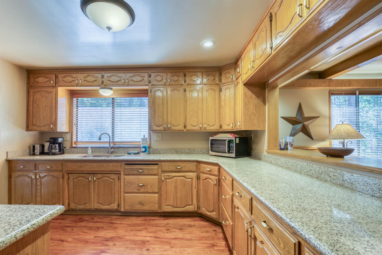 41593 Tollhouse Road Shaver Lake, CA 93664 - Photo 45 of 55 a kitchen with stainless steel appliances granite countertop a sink and a stove
