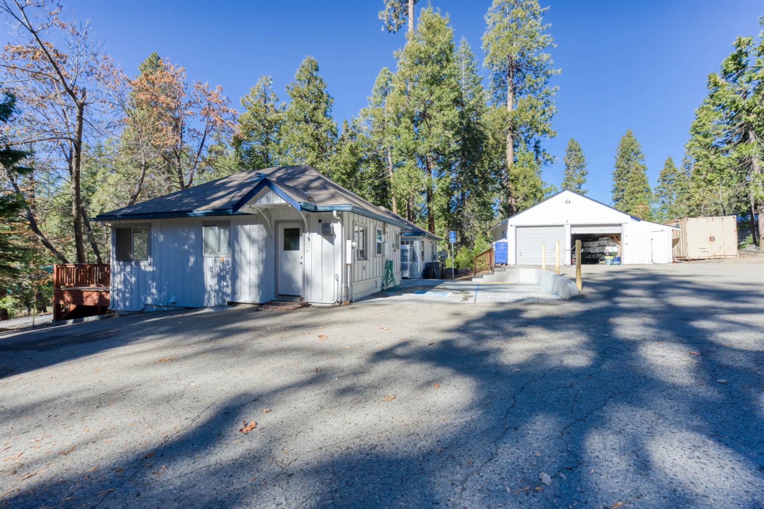 41593 Tollhouse Road Shaver Lake, CA 93664 - Photo 8 of 55 a front view of a house with yard and trees