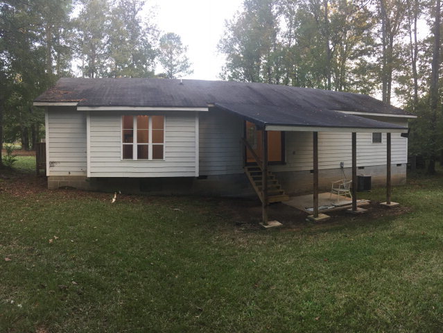 133 Stirk Road Macon, GA 31211 - Photo 14 of 16 a backyard of a house with plants and wooden fence