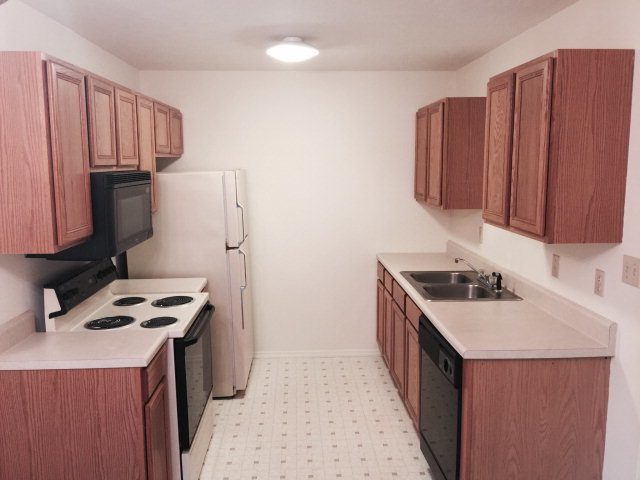 133 Stirk Road Macon, GA 31211 - Photo 5 of 16 a kitchen with granite countertop a sink stove and refrigerator