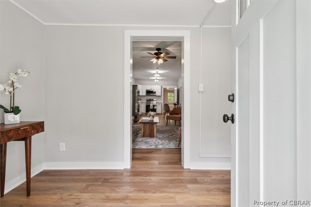 8213 Croaker Road Williamsburg, VA 23188 - Photo 6 of 50 Corridor featuring ornamental molding and hardwood / wood-style flooring