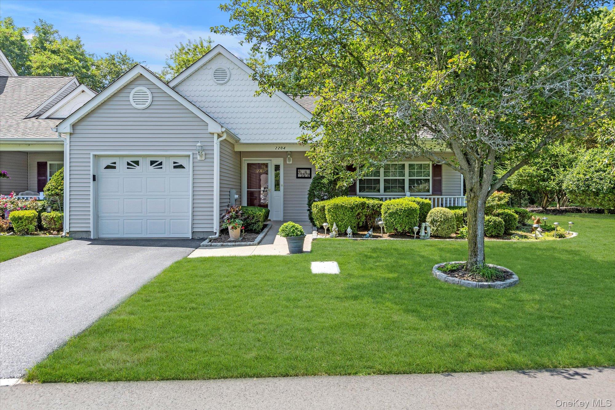 a front view of a house with a yard and green space