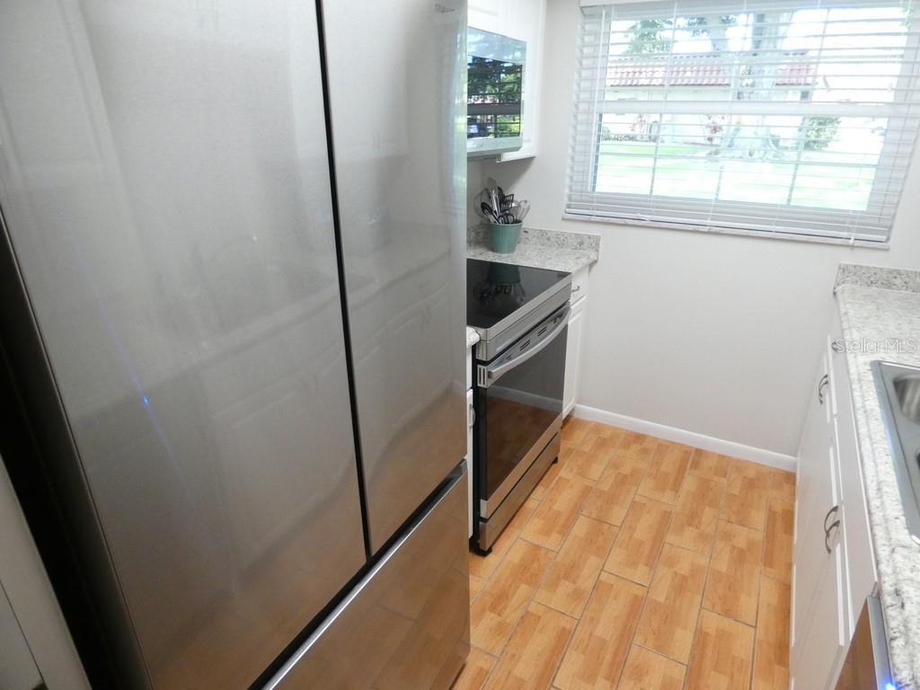 1701 Pinehurst Road, Unit 9G Dunedin, FL 34698 - Photo 9 of 22 a view of storage and utility room with washer and dryer