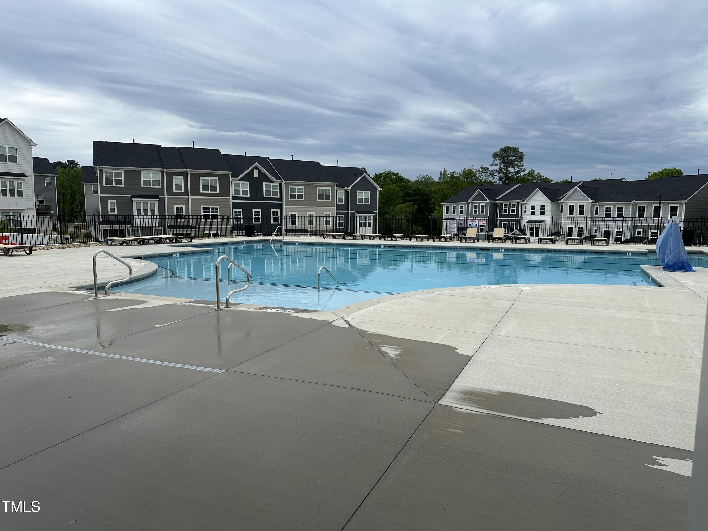 364 Devon Clfs Drive Wake Forest, NC 27587 - Photo 27 of 30 a view of swimming pool with outdoor seating and buildings in the background