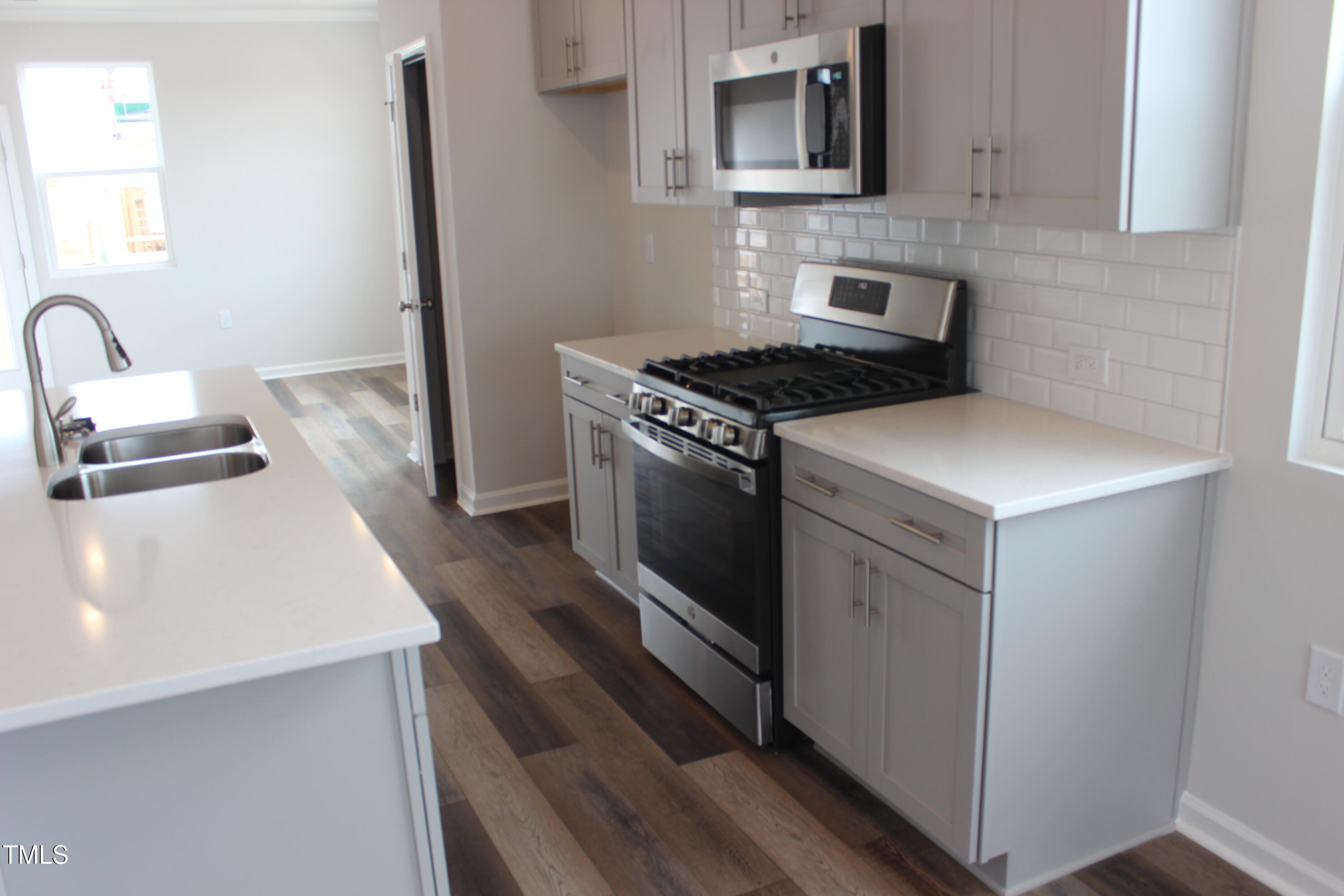 364 Devon Clfs Drive Wake Forest, NC 27587 - Photo 8 of 30 a kitchen with granite countertop a sink stove and refrigerator