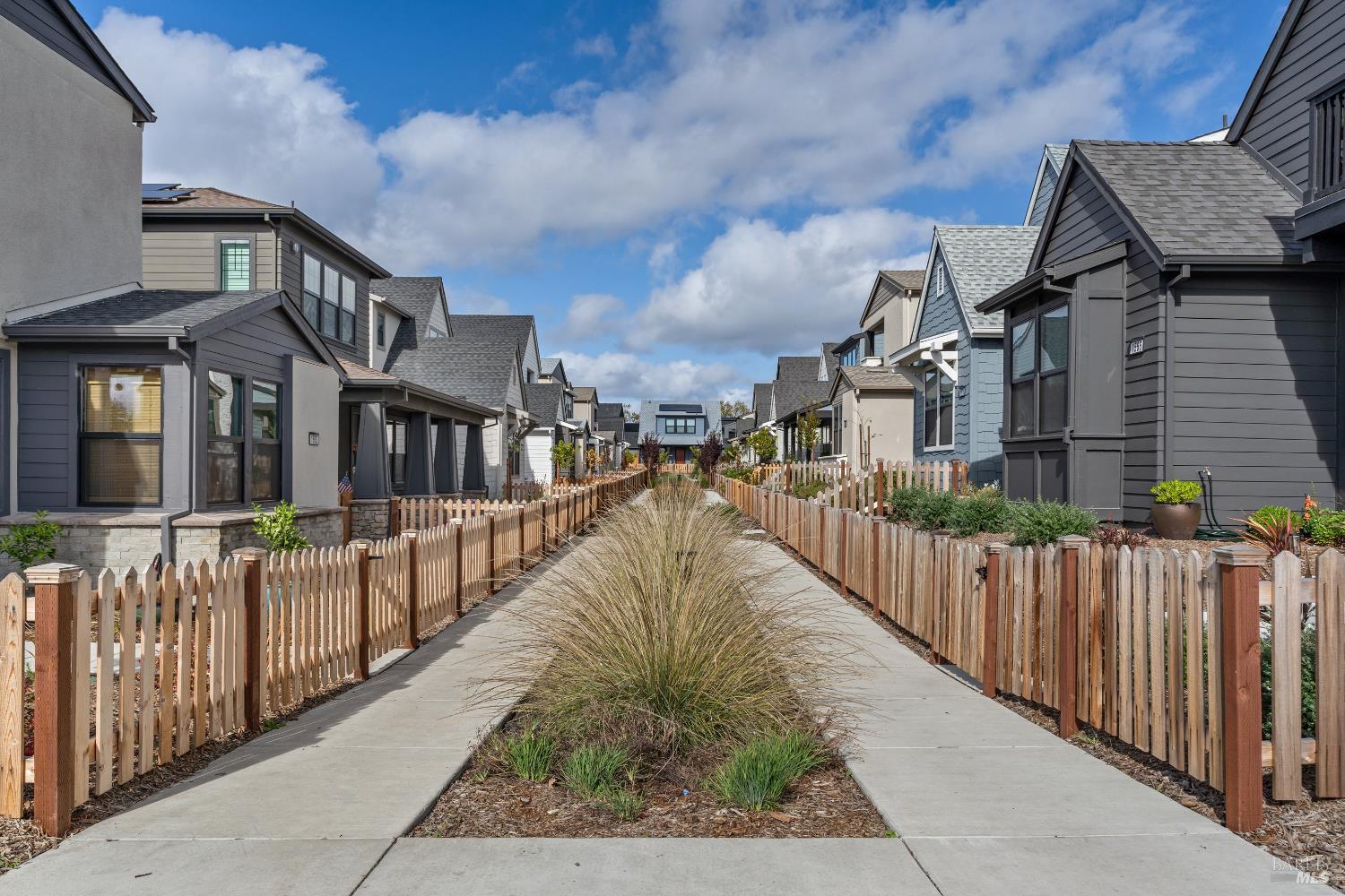 a view of a house with wooden fence
