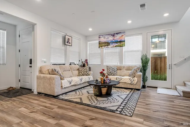 a living room with furniture or couch and a wooden floor