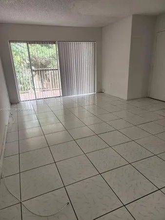 a view of an empty room and a window