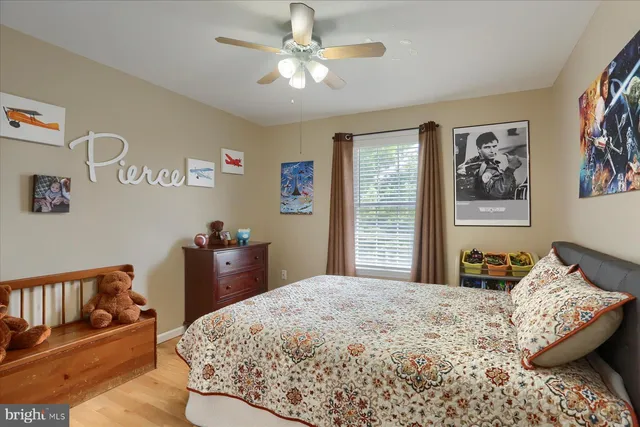 a bedroom with a bed and a painting on the wall