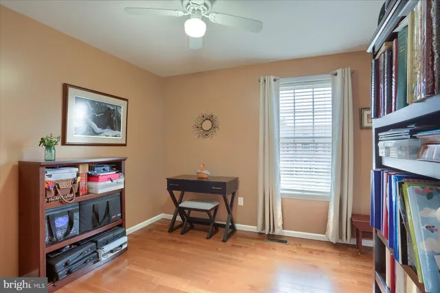 a view of a bedroom with furniture and book shelf