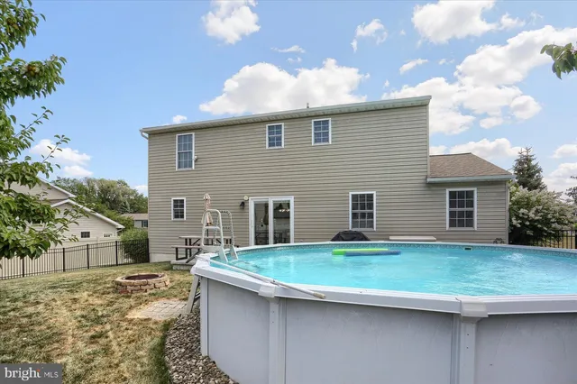 a backyard of a house with yard fire pit and outdoor seating