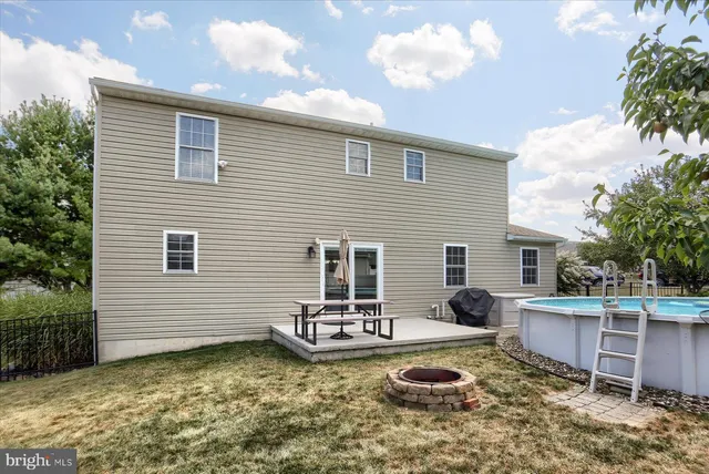a view of a house with backyard and sitting area