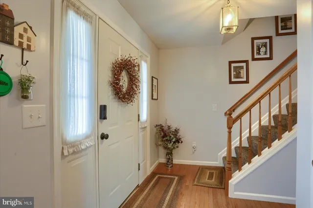a view of an entryway with wooden floor