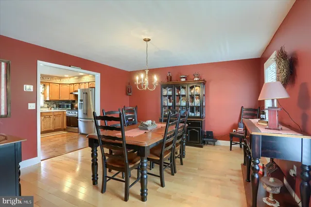 a view of a dining room with furniture and chandelier