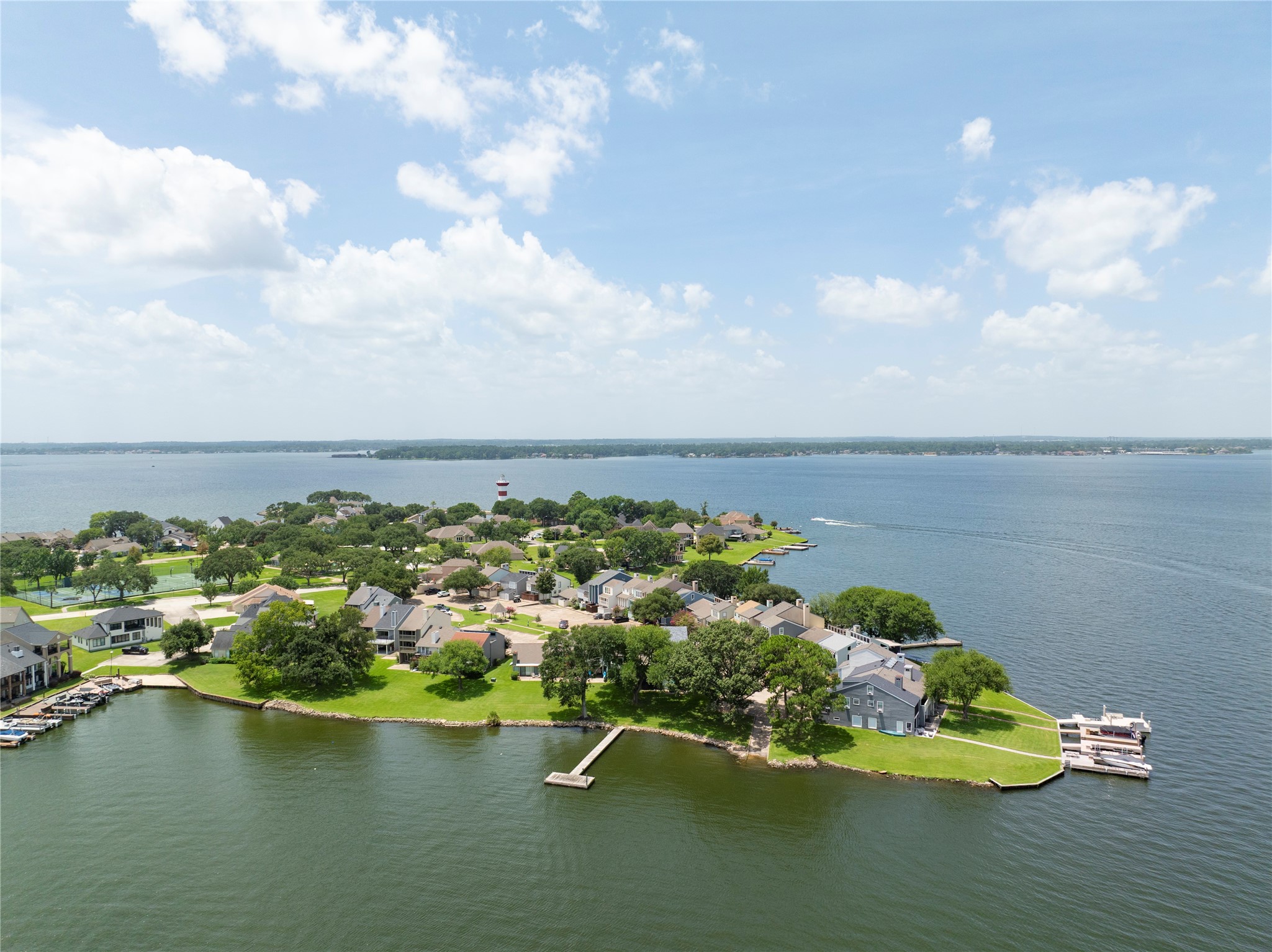 1436 Bowsprit Point Willis, TX 77318 - Photo 14 of 20 a view of a lake with lawn chairs