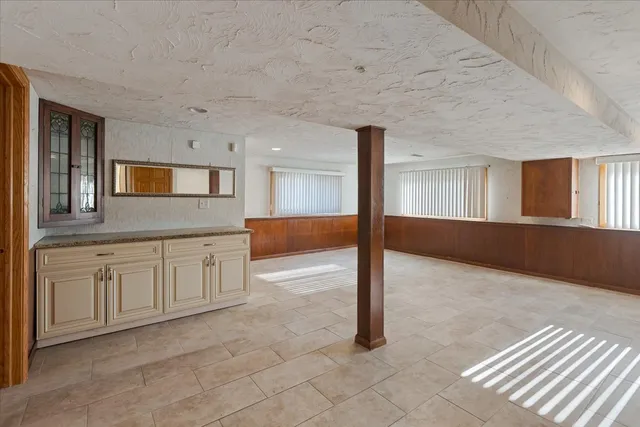 a view of a kitchen with furniture and wooden floor
