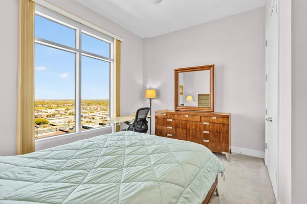 a bedroom with a bed and a dresser