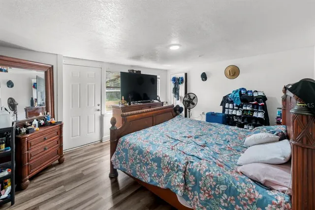 a bedroom with a bed and a flat screen tv