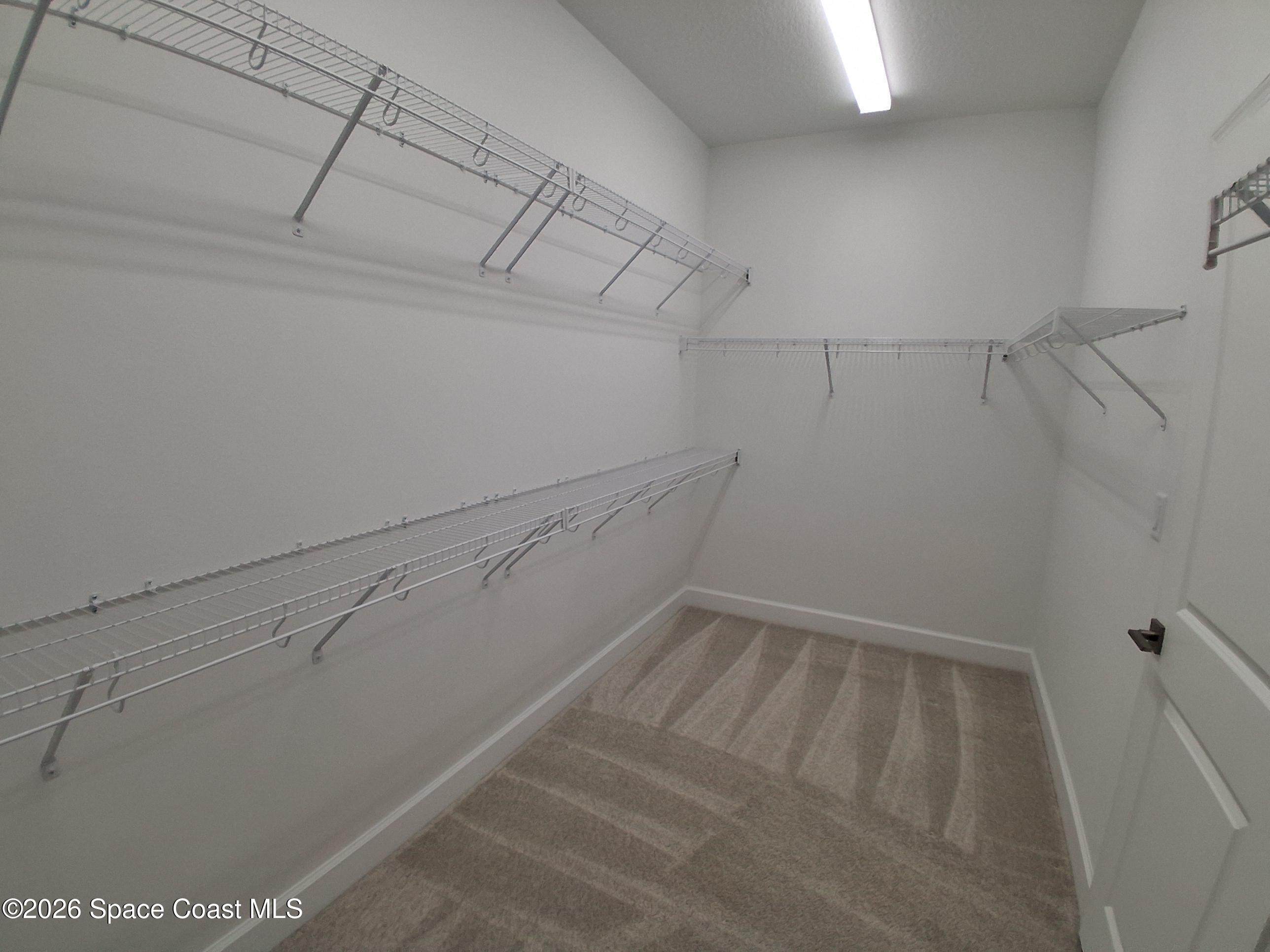 9292 Machin Place Melbourne, FL 32940 - Photo 14 of 41 a view of storage and utility room with racks on the wall