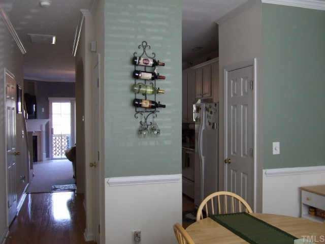 4806 Black Mountain Path Raleigh, NC 27612 - Photo 2 of 12 This view shows the hardwood floors and an open plan, allowing for good traffic flow. The half bath and stairs to the upper and lower levels are located on the left. Other