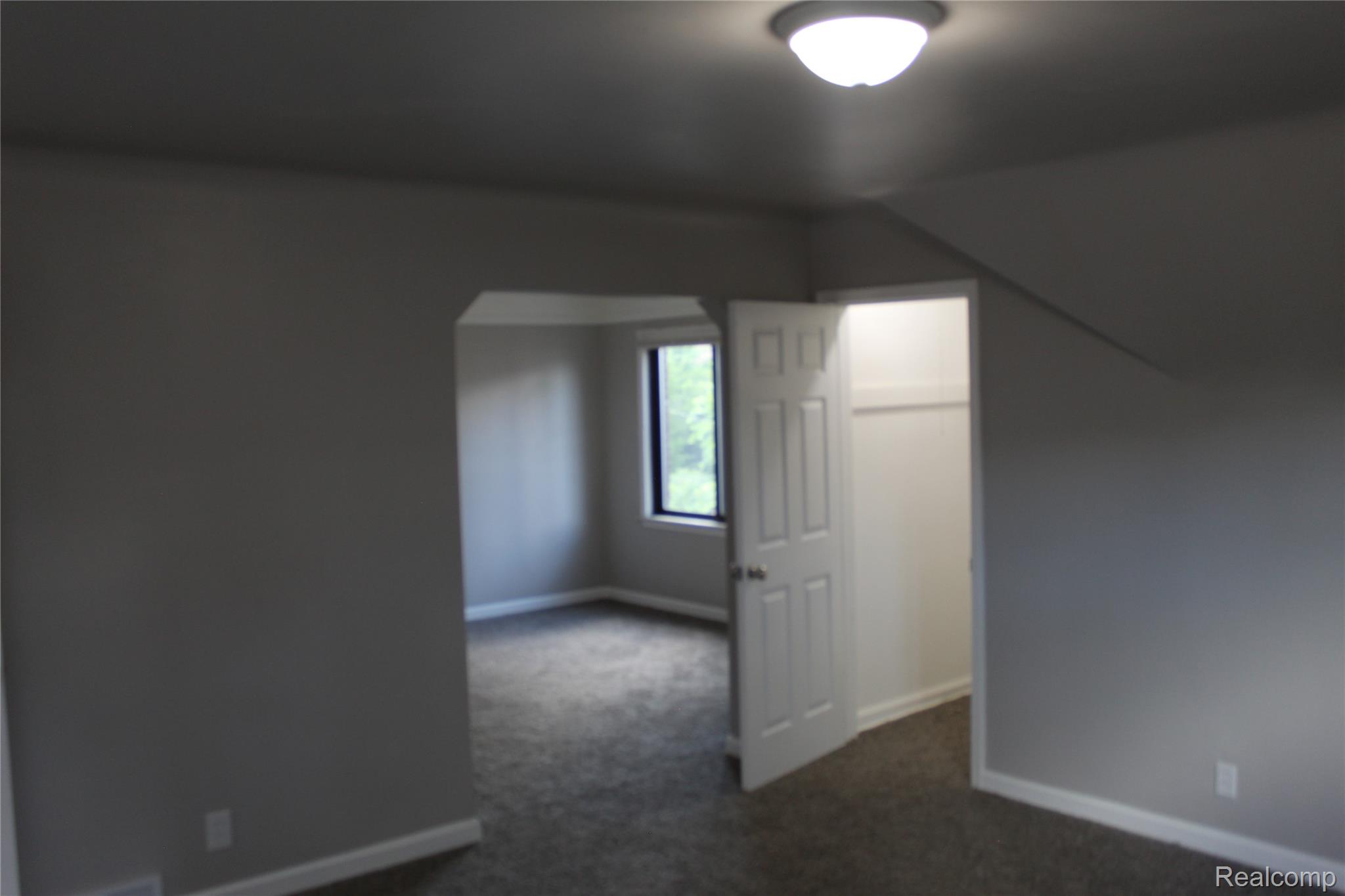 5543 Balfour Road Detroit, MI 48224 - Photo 47 of 54 Room featuring gray carpet flooring, white baseboards, and a semi-flush mount ceiling light