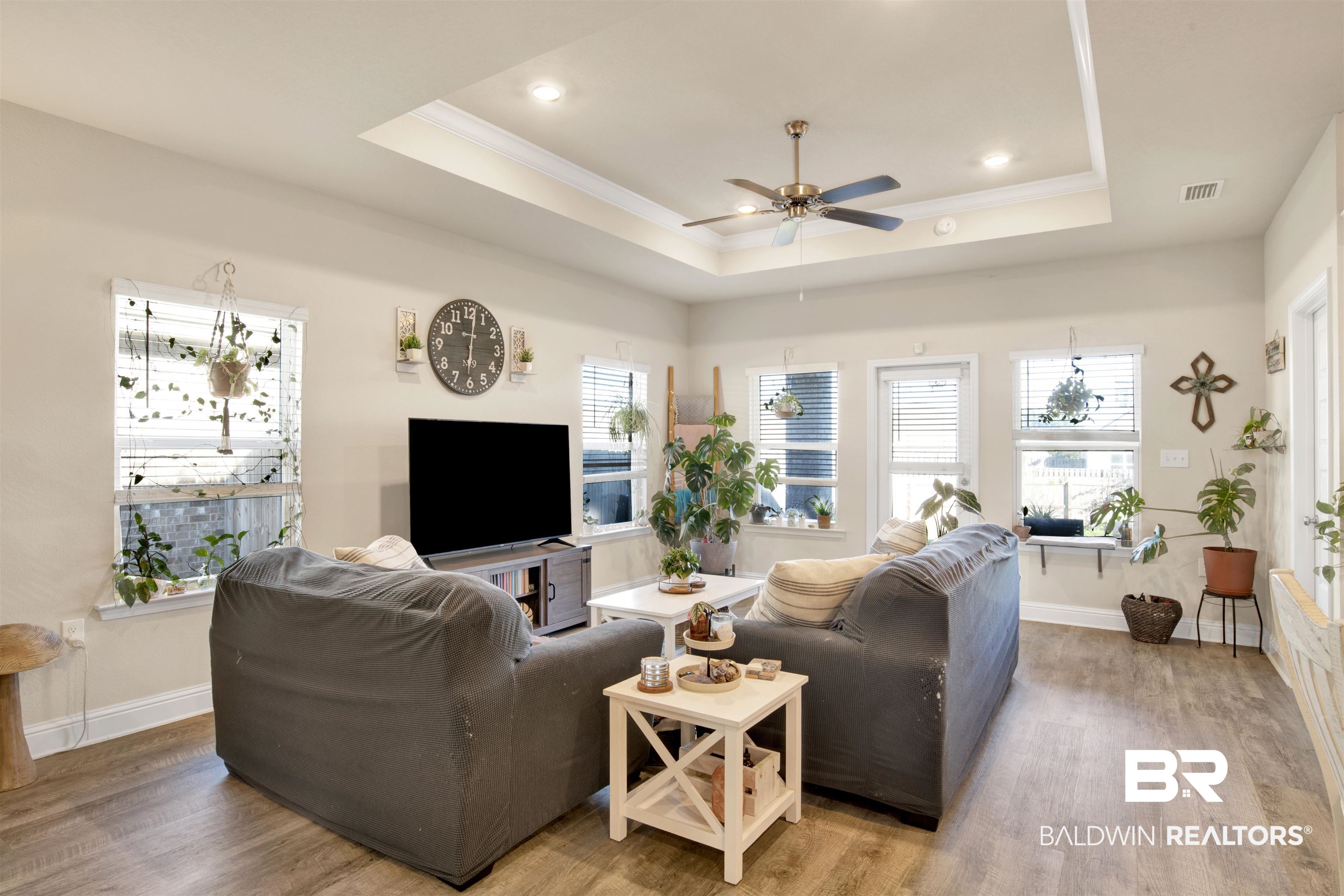 9622 Volterra Avenue Daphne, AL 36526 - Photo 11 of 31 Living room with hardwood / wood-style floors, a tray ceiling, ceiling fan, and a healthy amount of sunlight