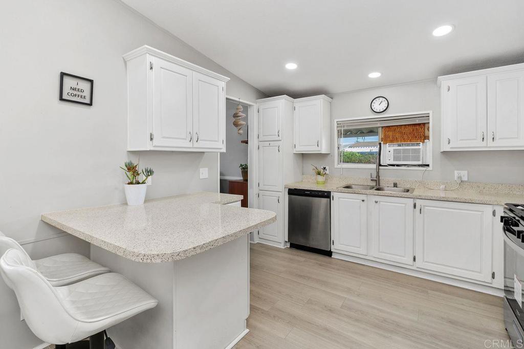 530 West Devonshire Avenue, Unit 84 Hemet, CA 92543 - Photo 17 of 36 a kitchen with stainless steel appliances white cabinets a sink and a stove
