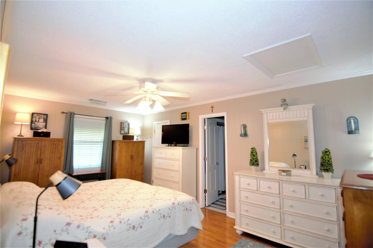 8517 Davidson Road Olive Branch, MS 38654 - Photo 11 of 24 a bedroom with a bed and a flat tv screen on dresser