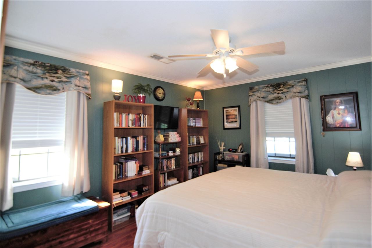 8517 Davidson Road Olive Branch, MS 38654 - Photo 13 of 24 a bedroom with a large bed and a chandelier