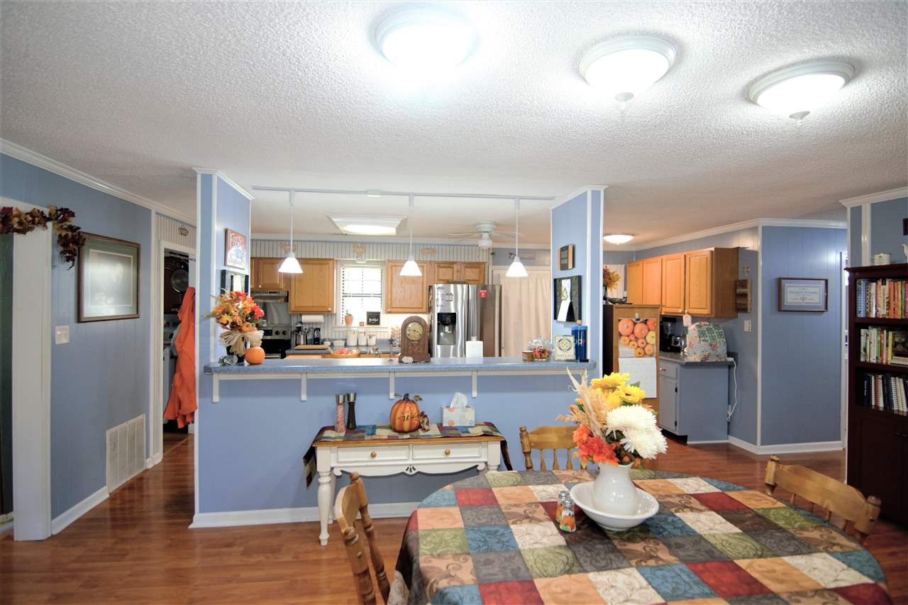 8517 Davidson Road Olive Branch, MS 38654 - Photo 4 of 24 a room with stainless steel appliances kitchen island granite countertop furniture and a wooden floor