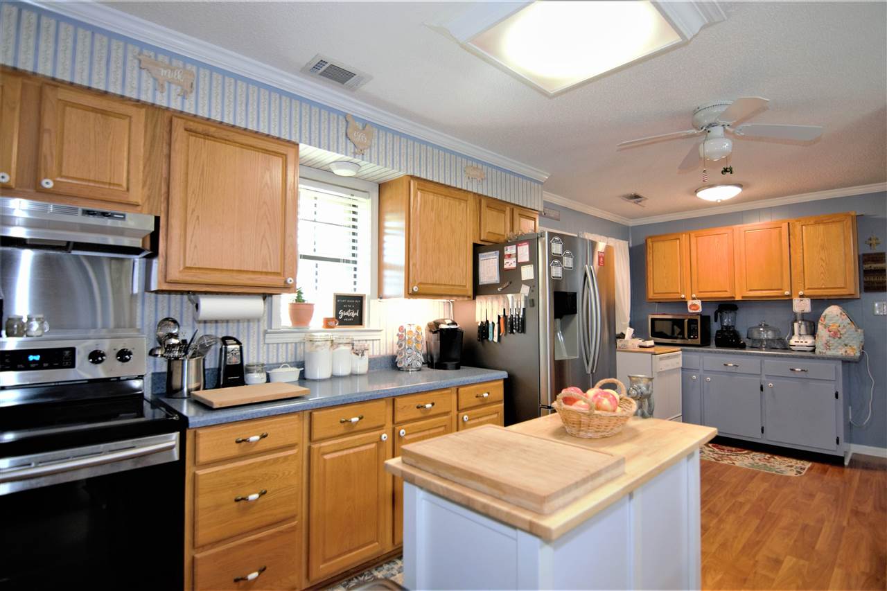 8517 Davidson Road Olive Branch, MS 38654 - Photo 7 of 24 a kitchen with stainless steel appliances granite countertop sink stove refrigerator and cabinets