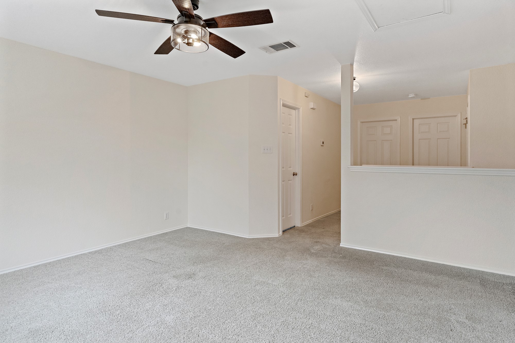 321 Nicole Way Bastrop, TX 78602 - Photo 12 of 32 Empty room featuring light carpet and a ceiling fan