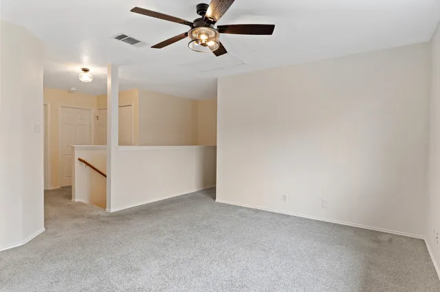 en empty room with closet and fan