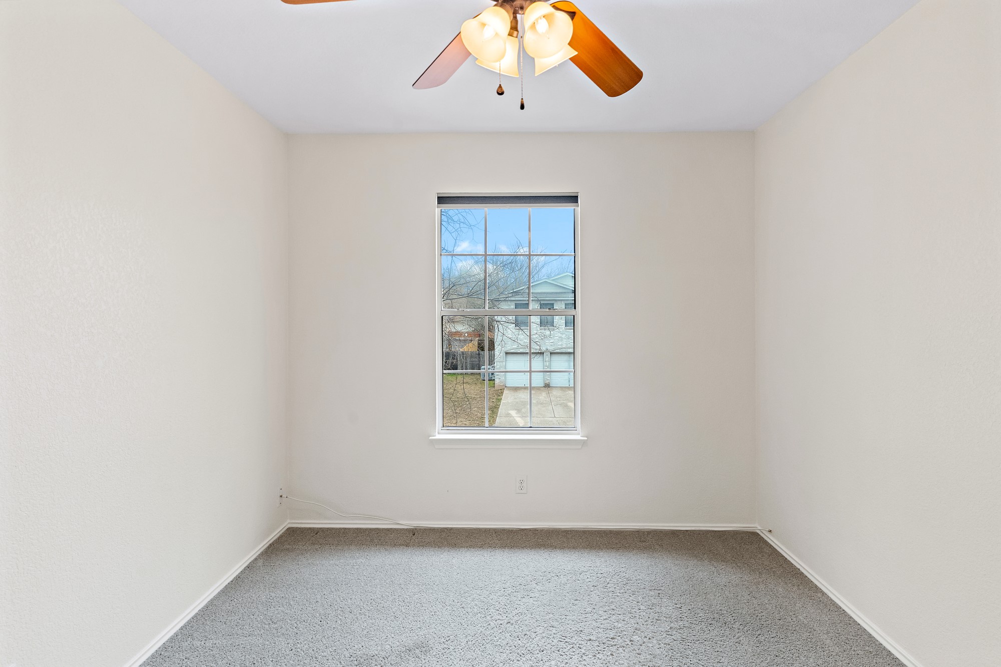 321 Nicole Way Bastrop, TX 78602 - Photo 15 of 32 Carpeted spare room featuring baseboards and a ceiling fan