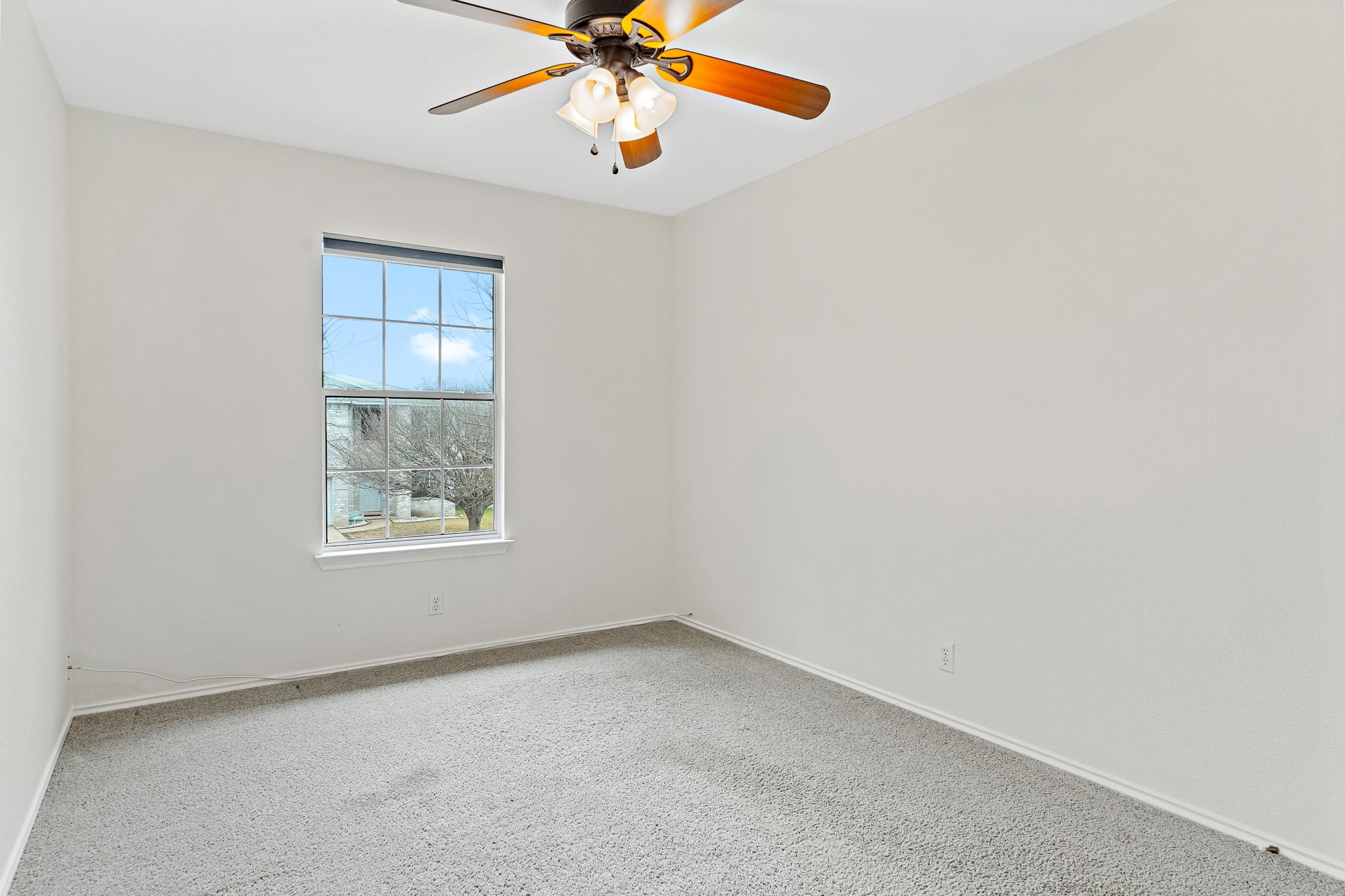 321 Nicole Way Bastrop, TX 78602 - Photo 16 of 32 Carpeted spare room featuring baseboards and ceiling fan