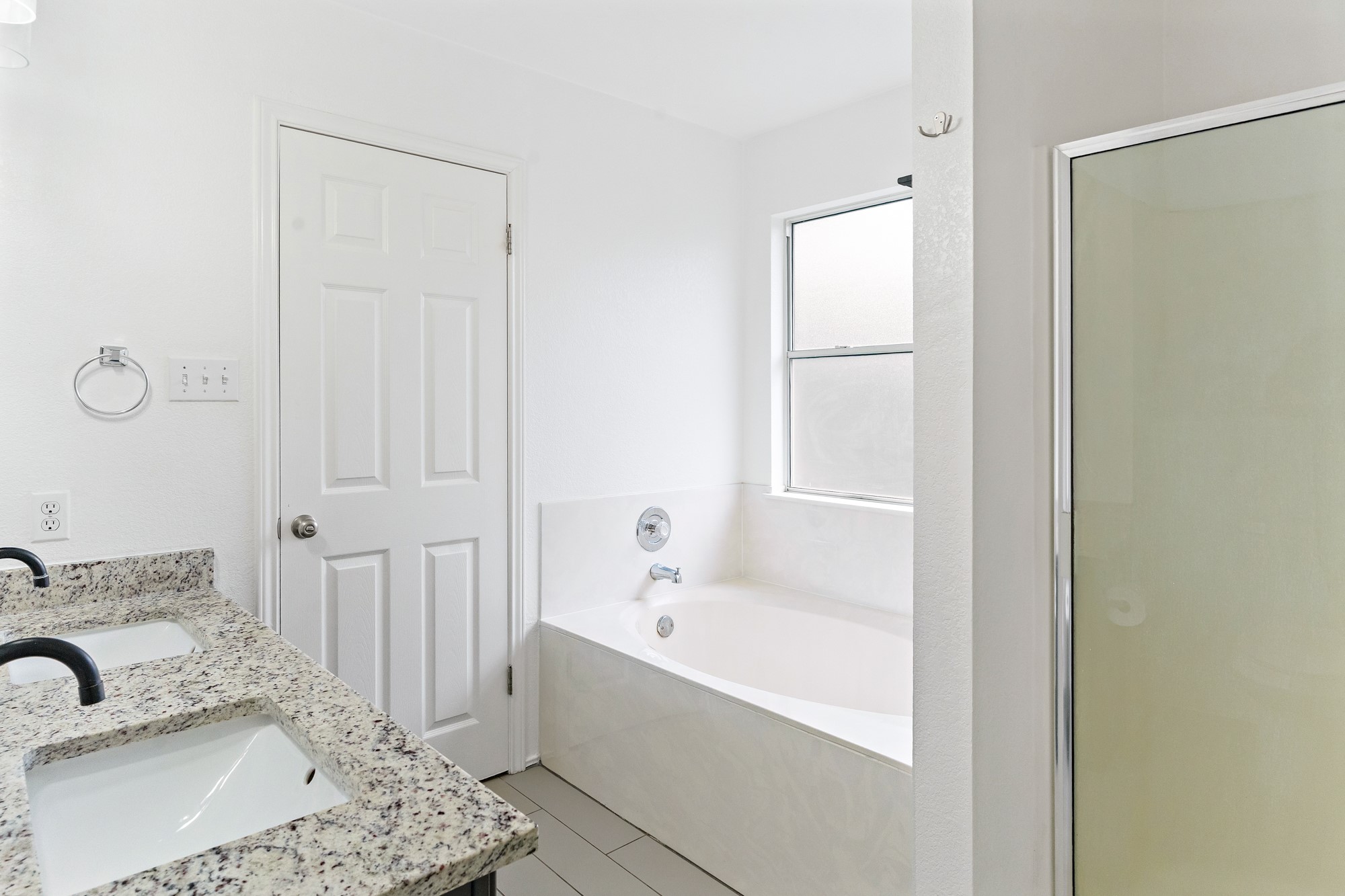 321 Nicole Way Bastrop, TX 78602 - Photo 21 of 32 Bathroom featuring double vanity, a garden tub, and a shower stall
